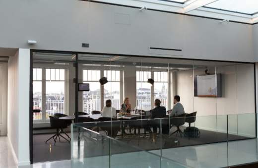 Glazen vergaderzaal met een team aan tafel